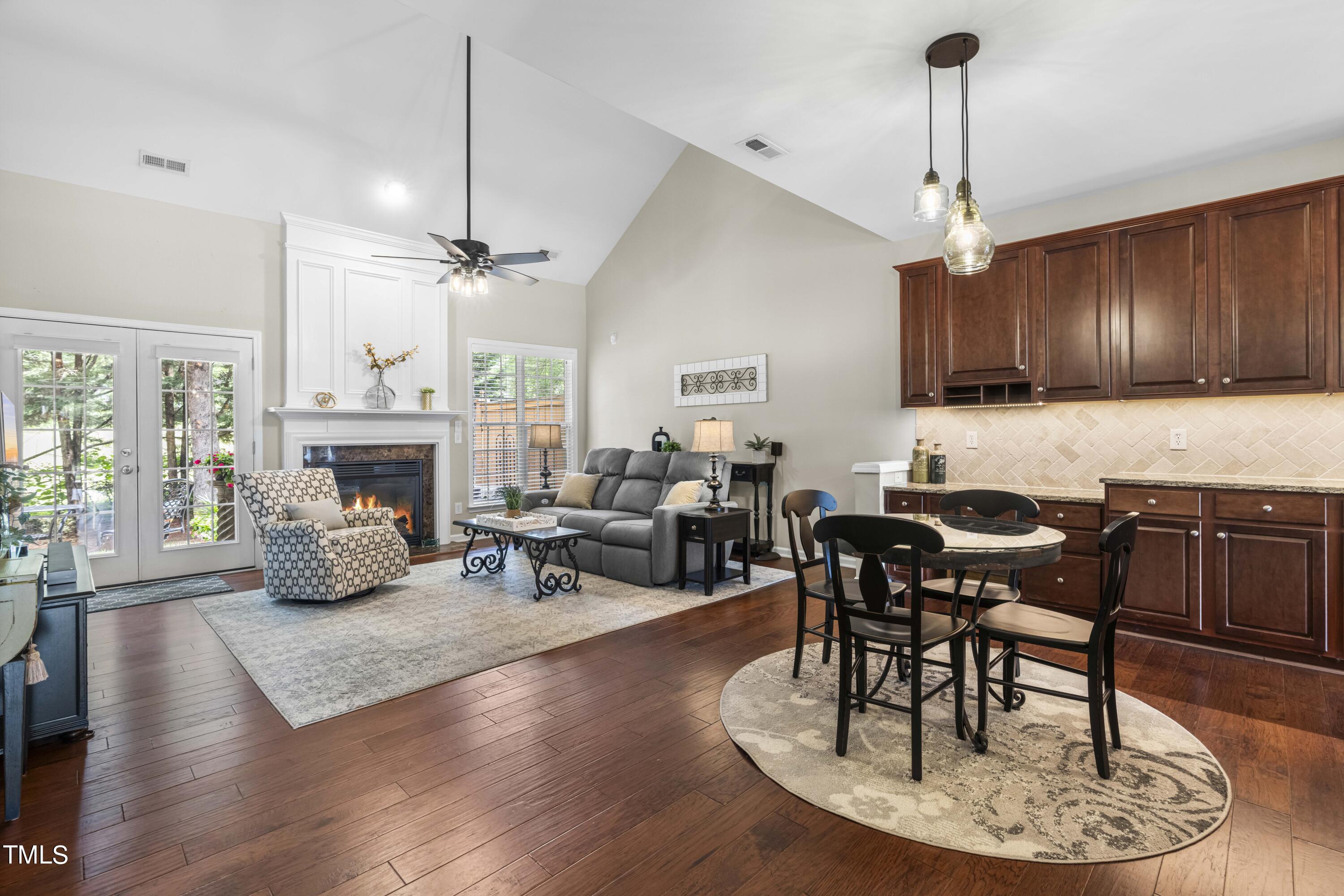 4604 Manassa Pope Lane Raleigh, NC 27612 - Photo 11 of 43 a living room with furniture a fireplace and a chandelier