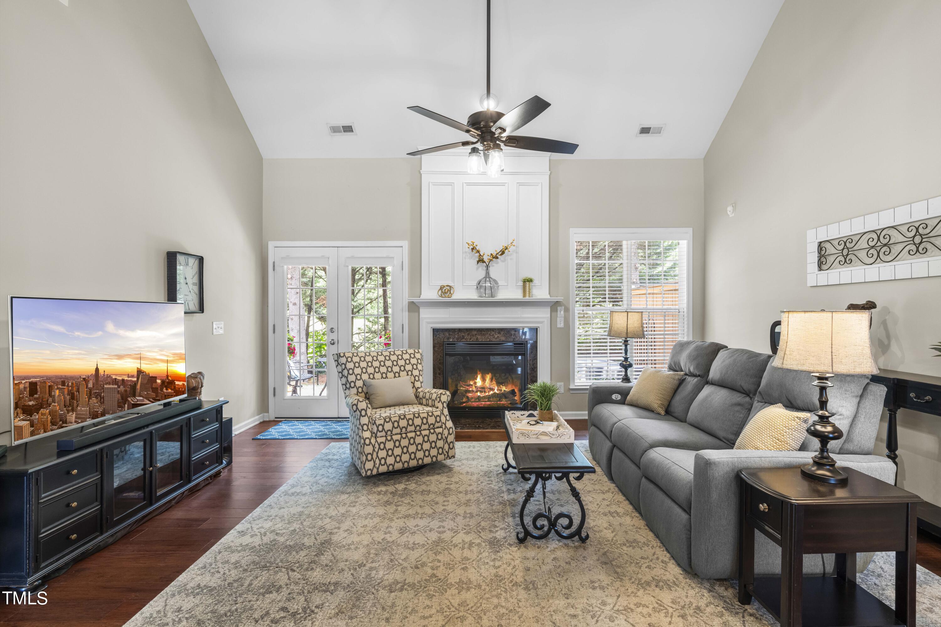4604 Manassa Pope Lane Raleigh, NC 27612 - Photo 14 of 43 a living room with furniture a flat screen tv and a fireplace