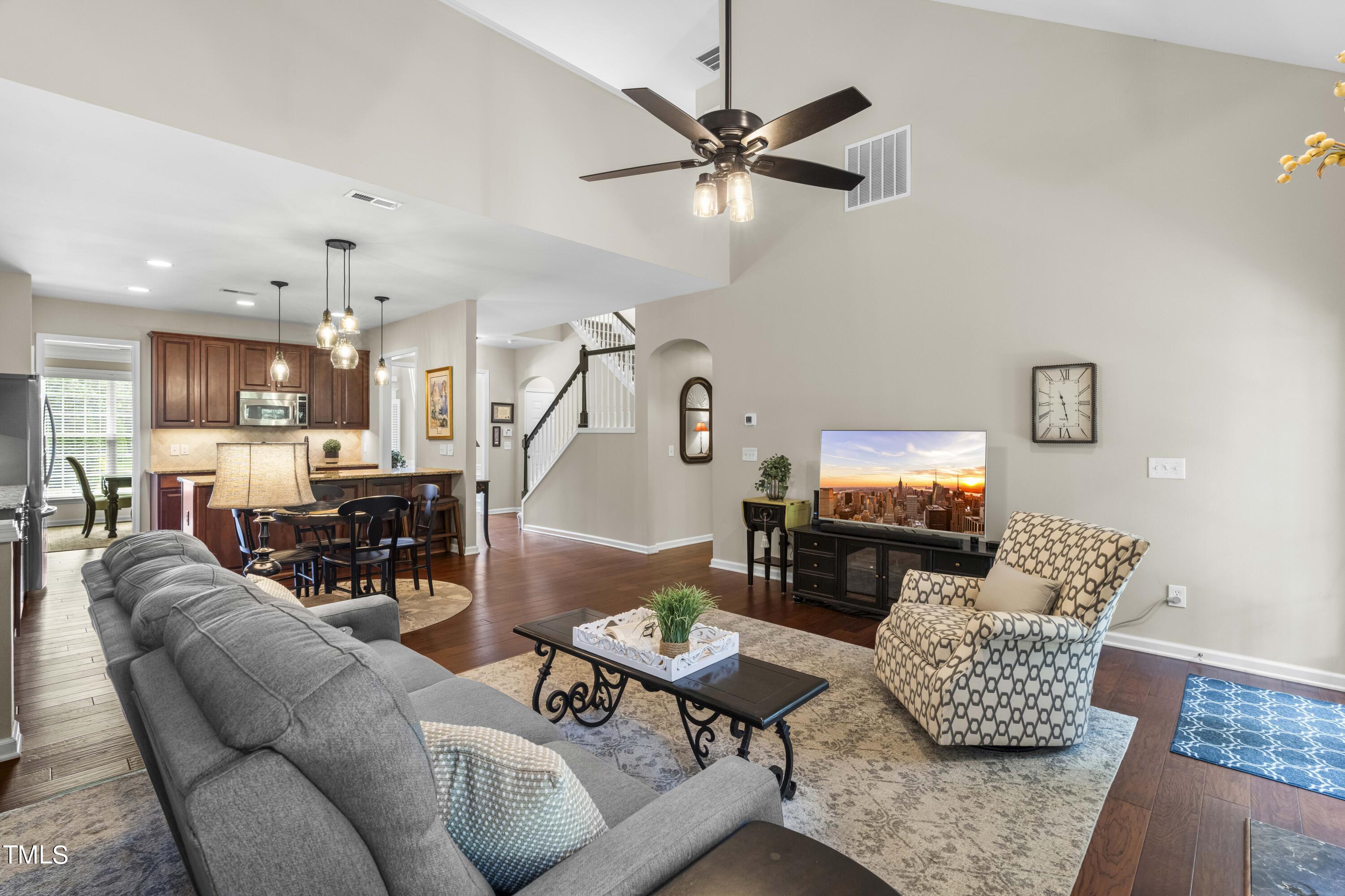 4604 Manassa Pope Lane Raleigh, NC 27612 - Photo 15 of 43 a living room with furniture and a flat screen tv with wooden floor