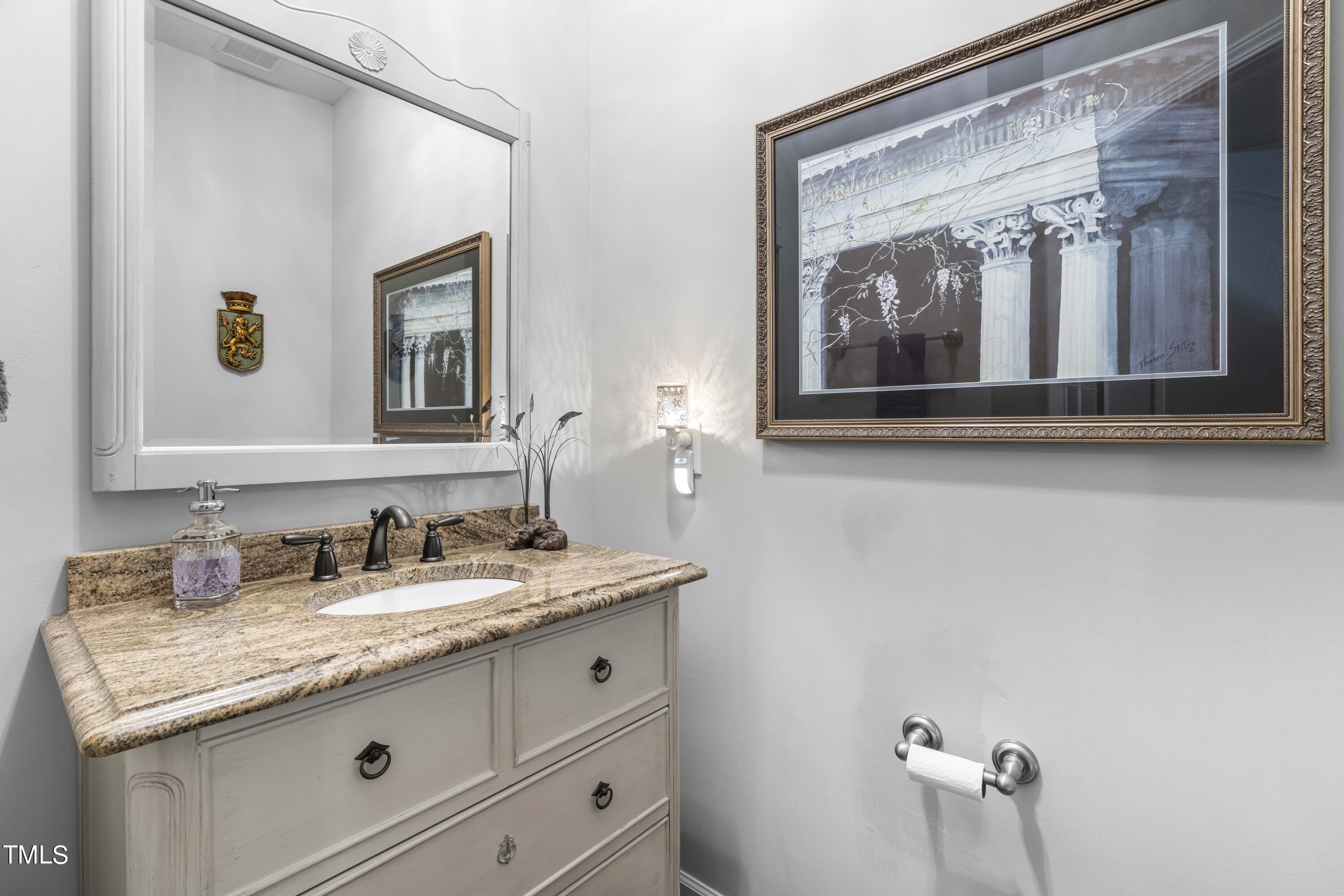 4604 Manassa Pope Lane Raleigh, NC 27612 - Photo 16 of 43 a bathroom with a granite countertop sink and a mirror