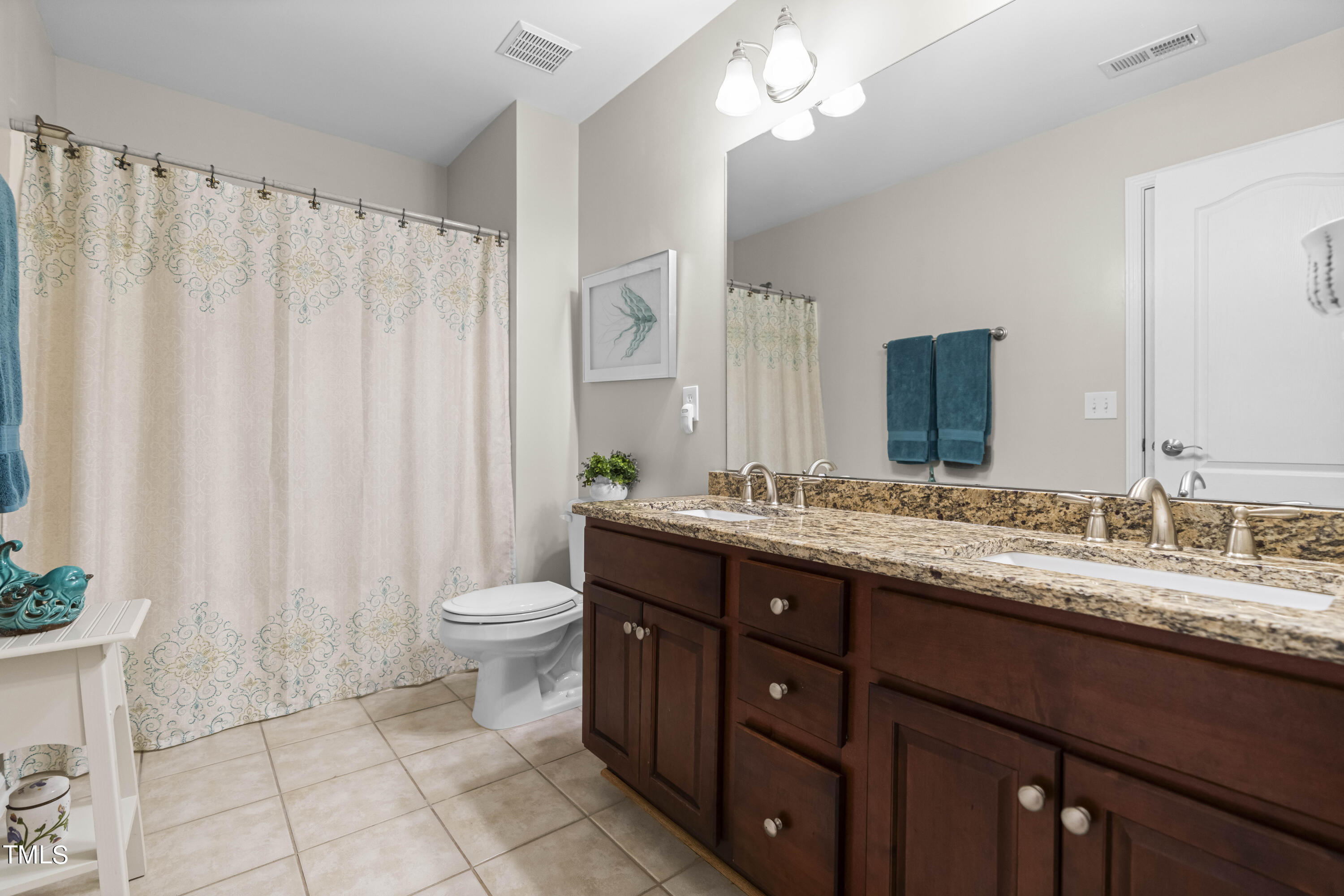 4604 Manassa Pope Lane Raleigh, NC 27612 - Photo 29 of 43 a bathroom with a double vanity sink toilet and a mirror