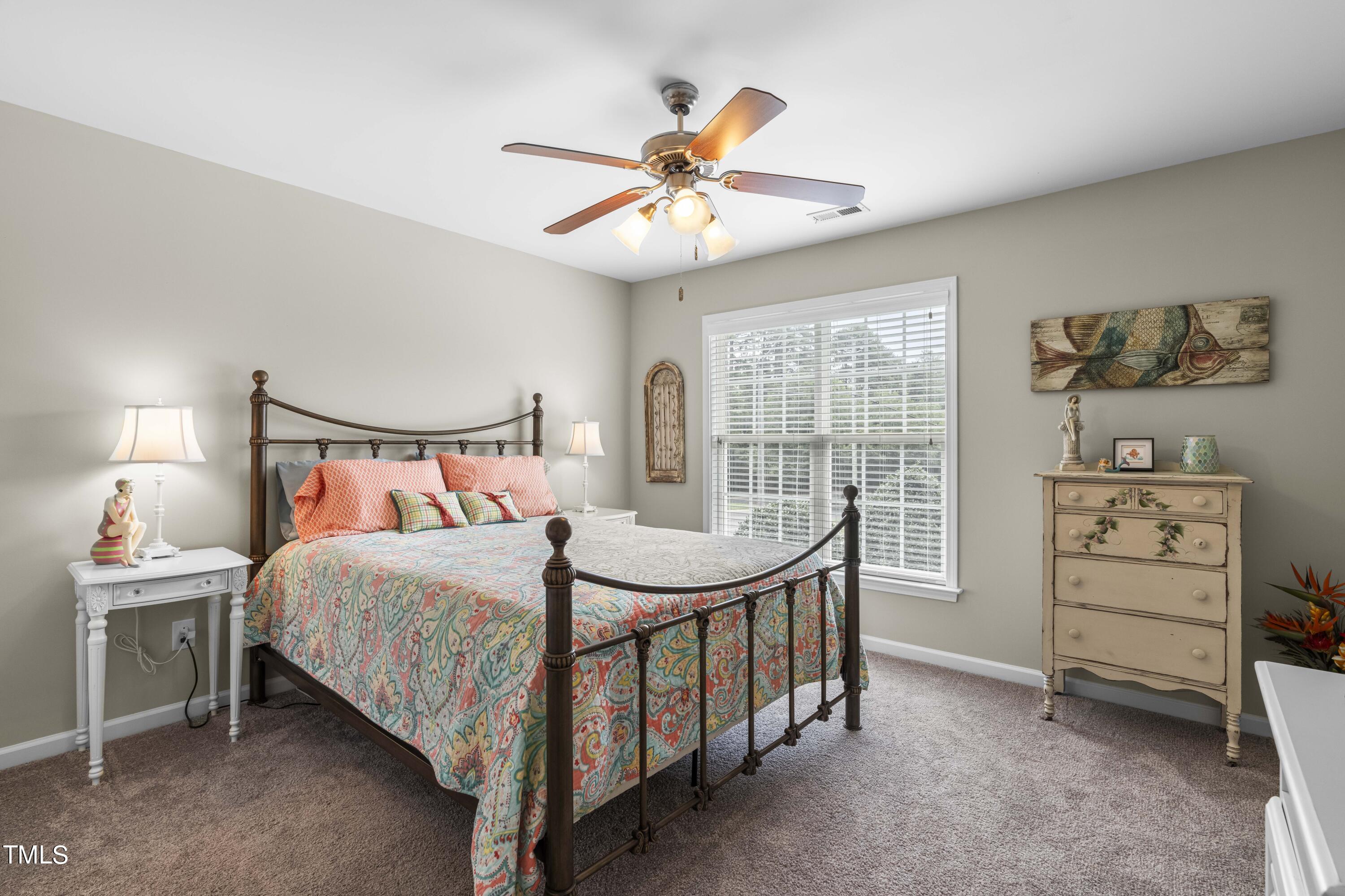 4604 Manassa Pope Lane Raleigh, NC 27612 - Photo 30 of 43 a bedroom with a bed and a chandelier