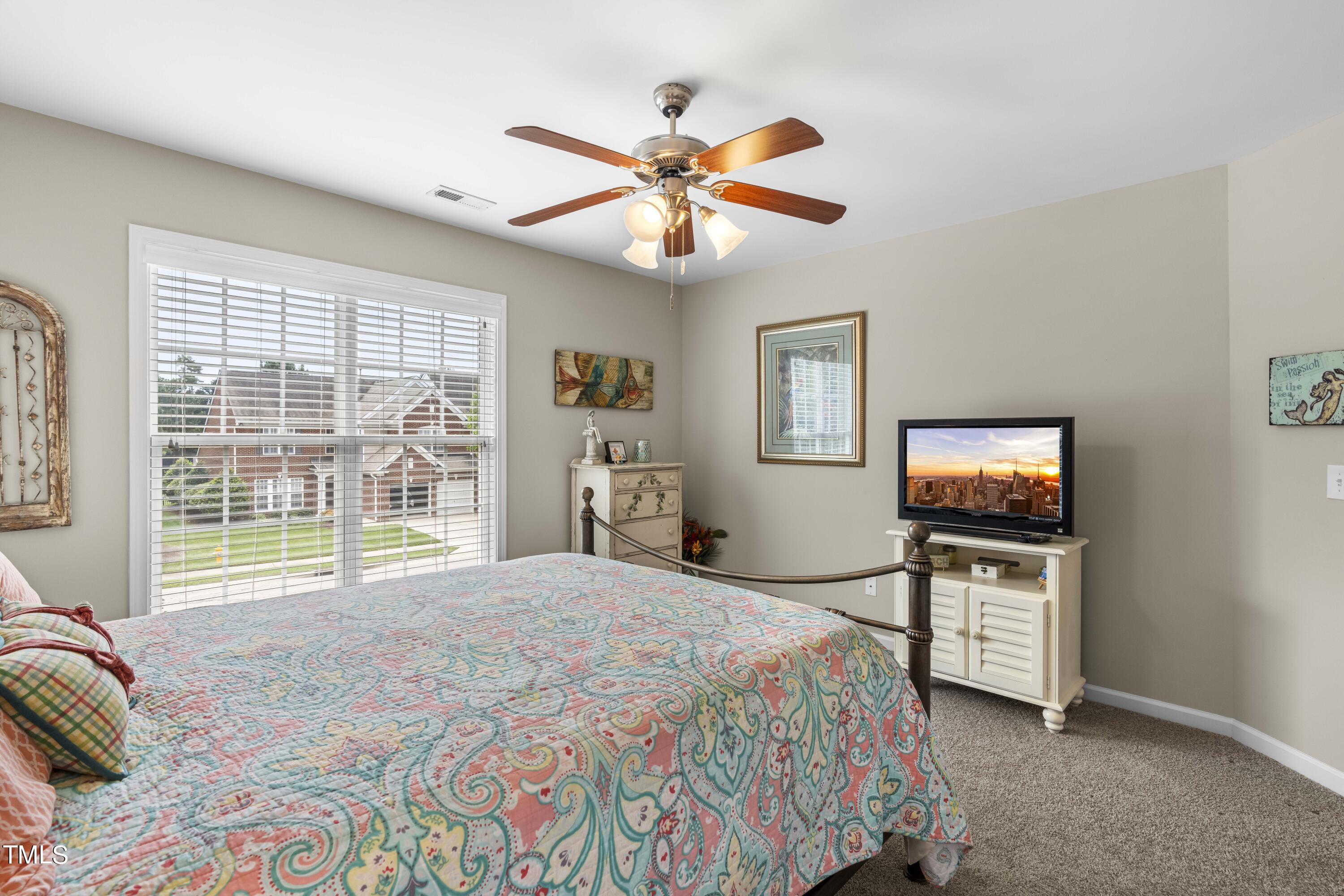 4604 Manassa Pope Lane Raleigh, NC 27612 - Photo 31 of 43 a bedroom with a bed and a large window