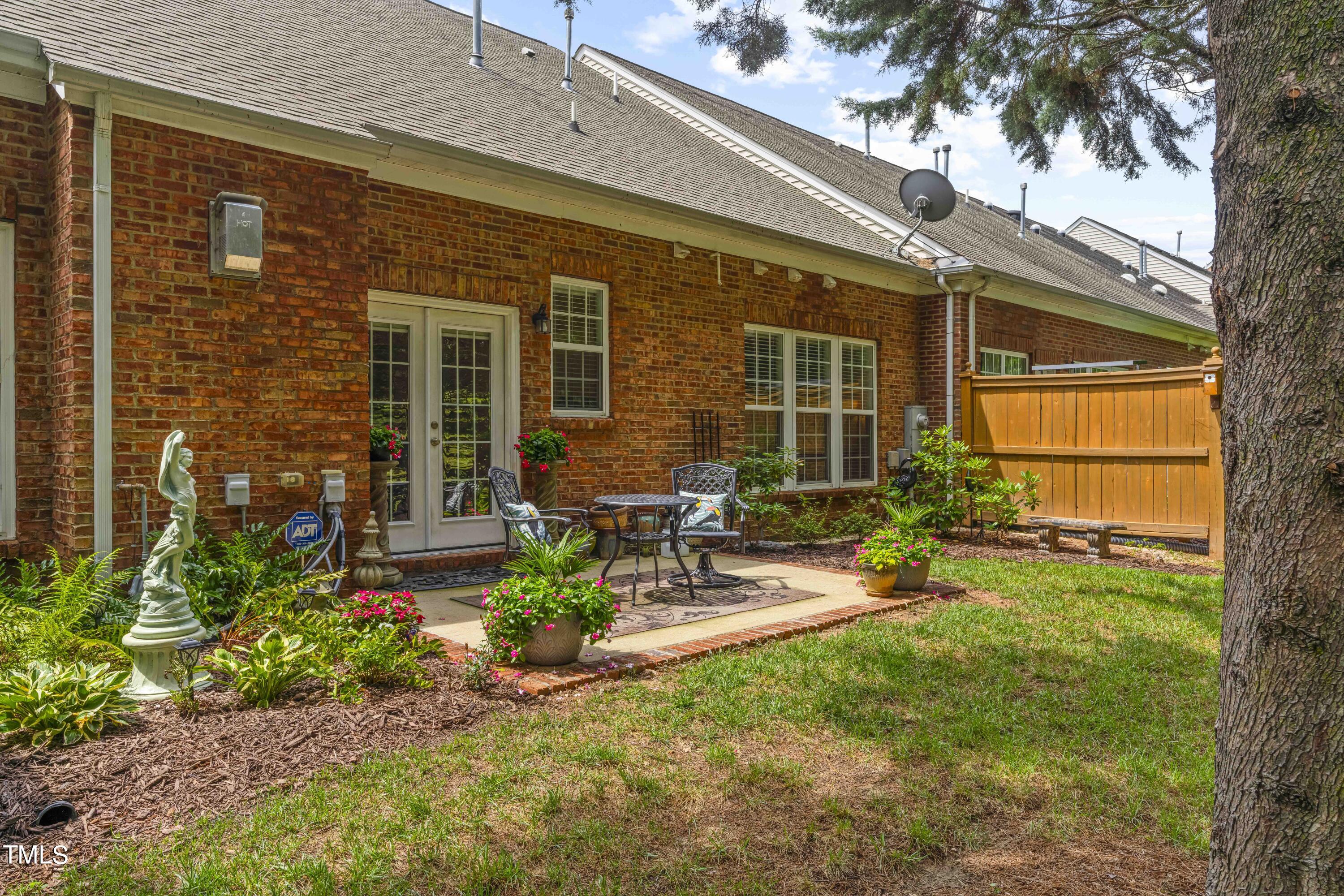 4604 Manassa Pope Lane Raleigh, NC 27612 - Photo 39 of 43 a view of backyard with a table and chairs and potted plants
