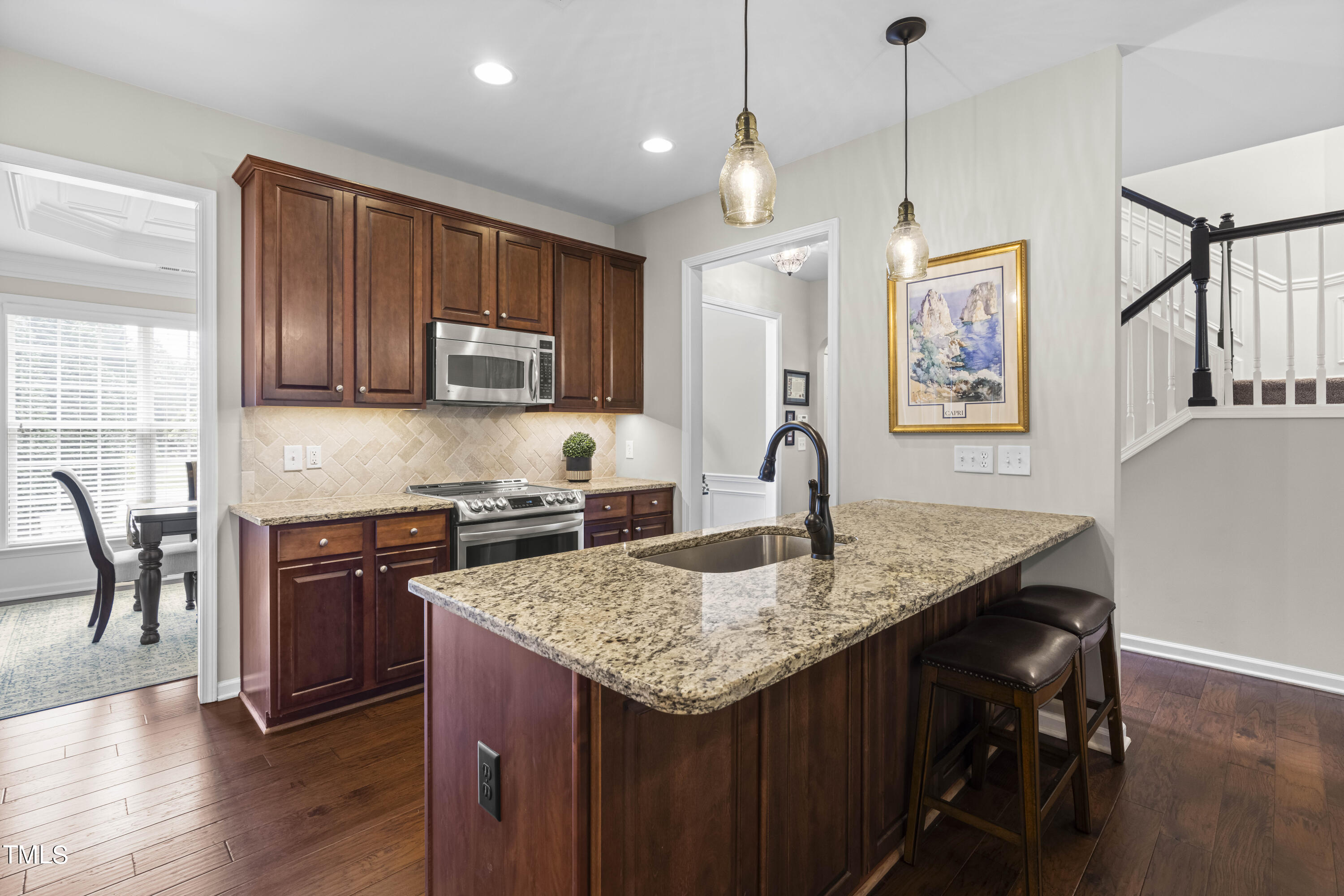 4604 Manassa Pope Lane Raleigh, NC 27612 - Photo 9 of 43 a kitchen with granite countertop kitchen island a table and chairs in it