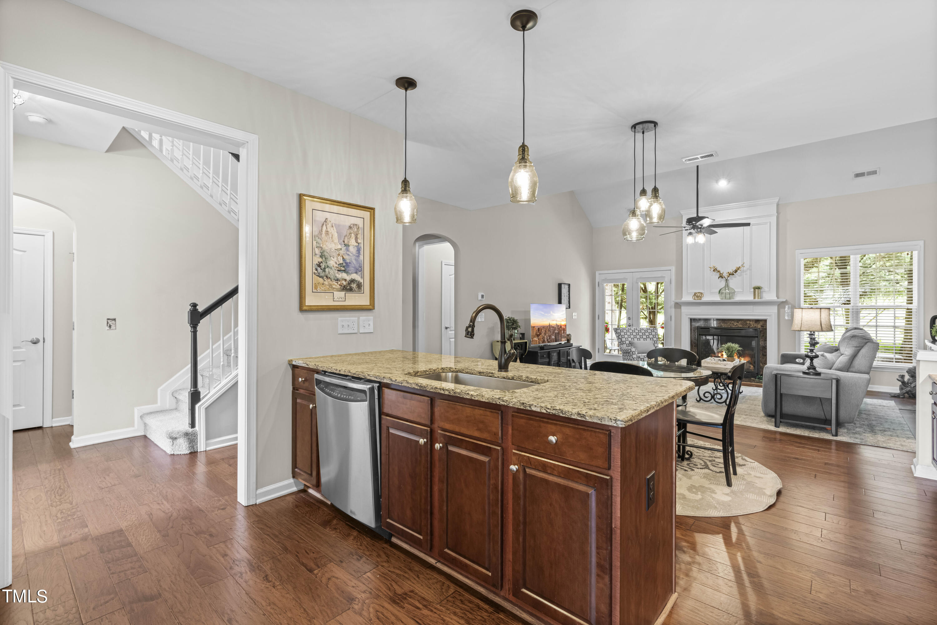 4604 Manassa Pope Lane Raleigh, NC 27612 - Photo 10 of 43 a view of a kitchen counter top space with granite countertop wooden floor living room and stainless steel appliances