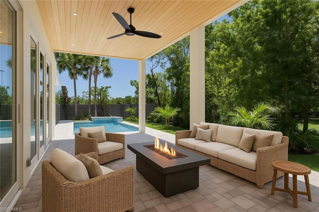 2854 Coach House Way Naples, FL 34105 - Photo 11 of 45 Fenced backyard with an outdoor living space with a fire pit, a patio area, and ceiling fan