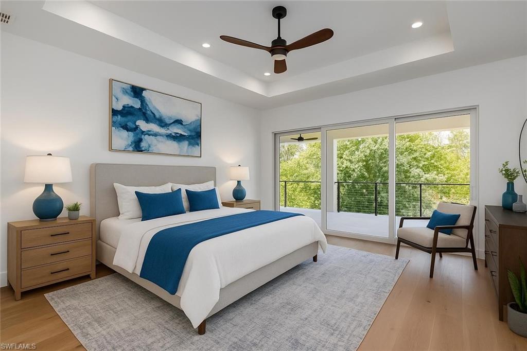 2854 Coach House Way Naples, FL 34105 - Photo 12 of 45 Bedroom featuring a raised ceiling, light wood-style flooring, access to exterior, and recessed lighting