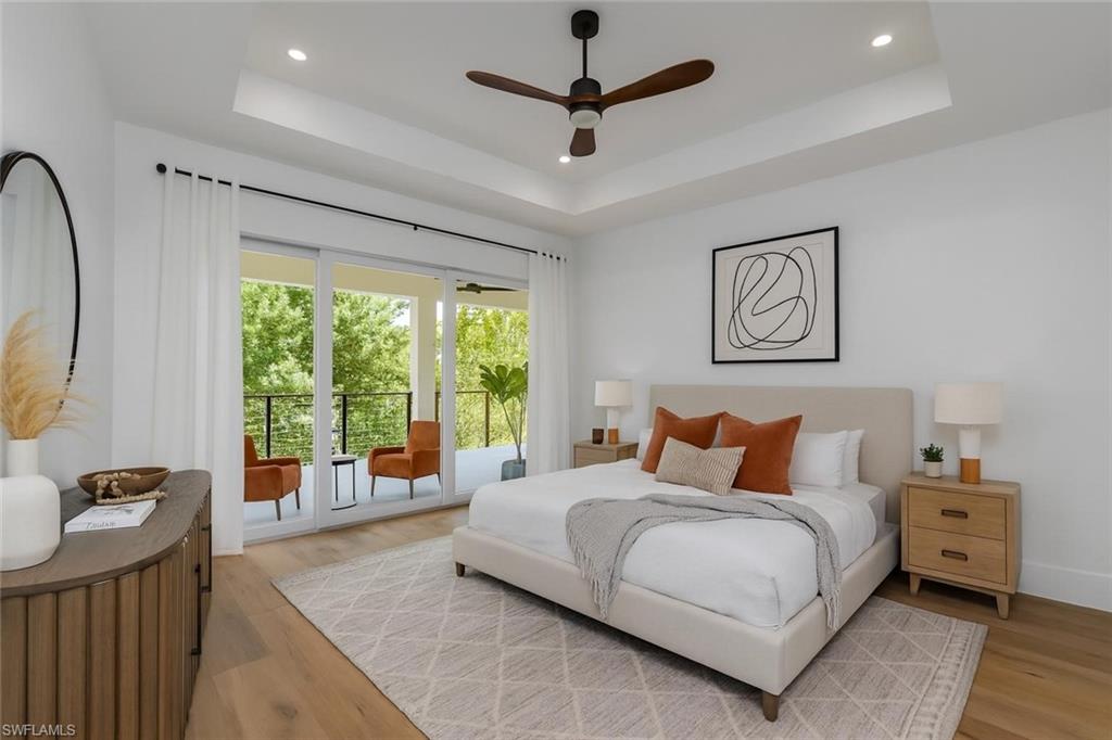 2854 Coach House Way Naples, FL 34105 - Photo 14 of 45 Bedroom with light wood-style flooring, a ceiling fan, recessed lighting, and a tray ceiling