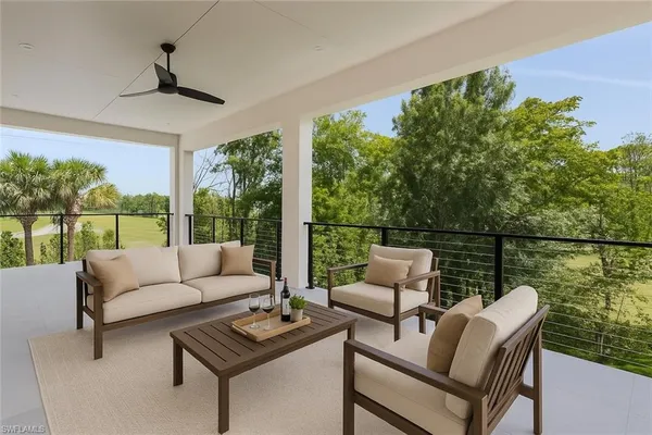 a balcony with furniture and a potted plant