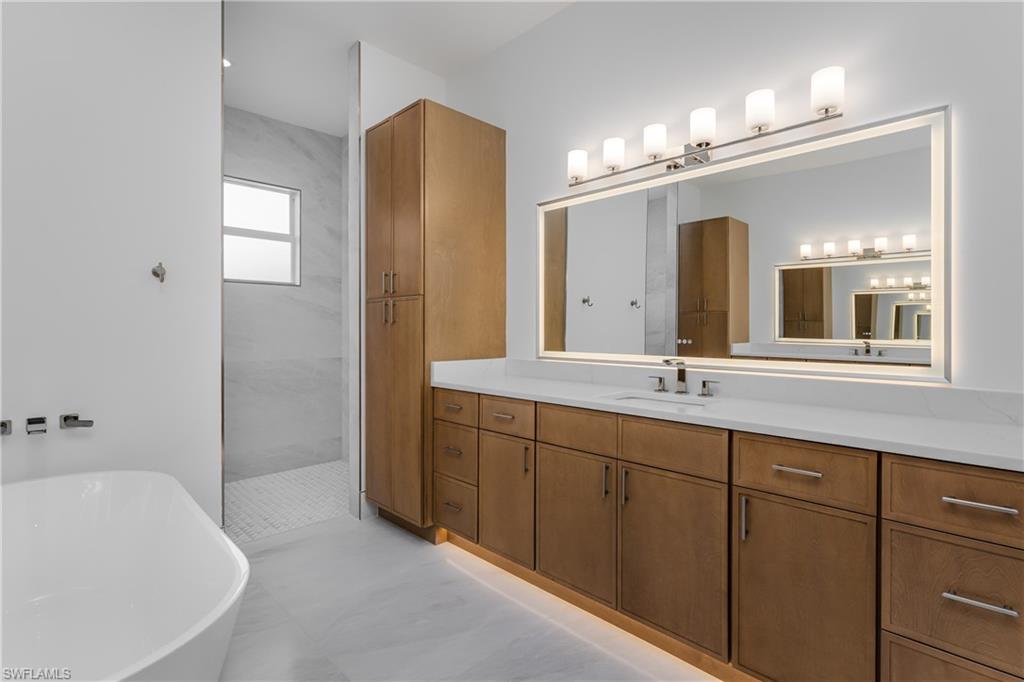 2854 Coach House Way Naples, FL 34105 - Photo 22 of 50 Full bath with a soaking tub, vanity, and walk in shower