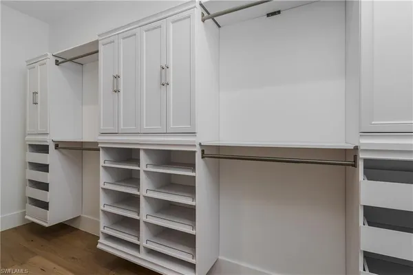 a view of walk in closet with empty racks