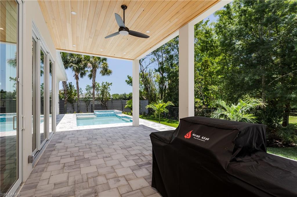 2854 Coach House Way Naples, FL 34105 - Photo 34 of 45 Fenced backyard featuring a patio area, a grill, ceiling fan, and a pool with connected hot tub