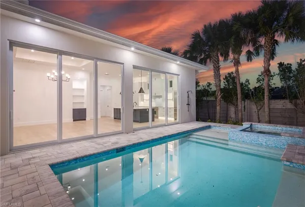 a view of a house with a backyard and a patio