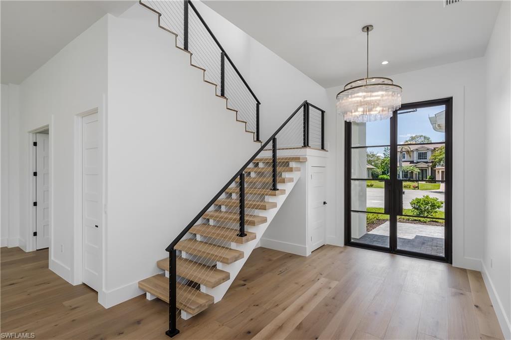 2854 Coach House Way Naples, FL 34105 - Photo 5 of 50 Foyer entrance featuring stairs, wood finished floors, a chandelier, and recessed lighting