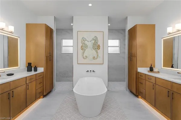 a spacious bathroom with a tub sink and mirror