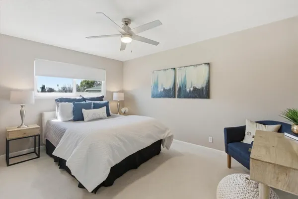 a bathroom with a sink a toilet a mirror and shower