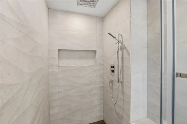 a kitchen with white cabinets and a window