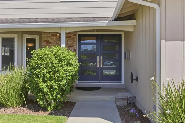 a kitchen with a sink cabinets and dining table chair