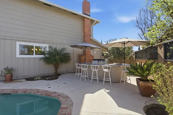 a view of backyard with outdoor seating and plants