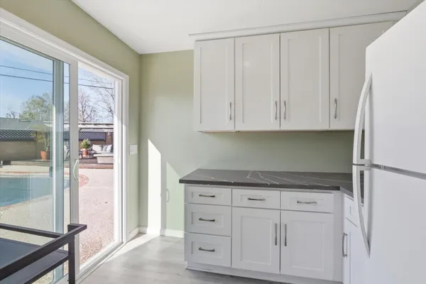 a view of a house with backyard and sitting area