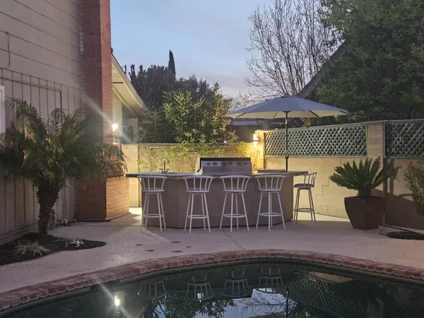 a view of a chairs and tables in the back yard