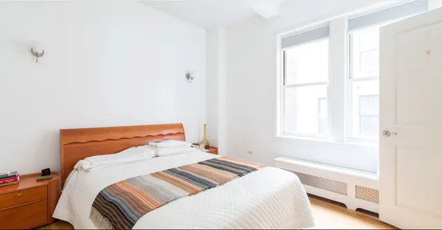 a bedroom with a bed and a window with outer view
