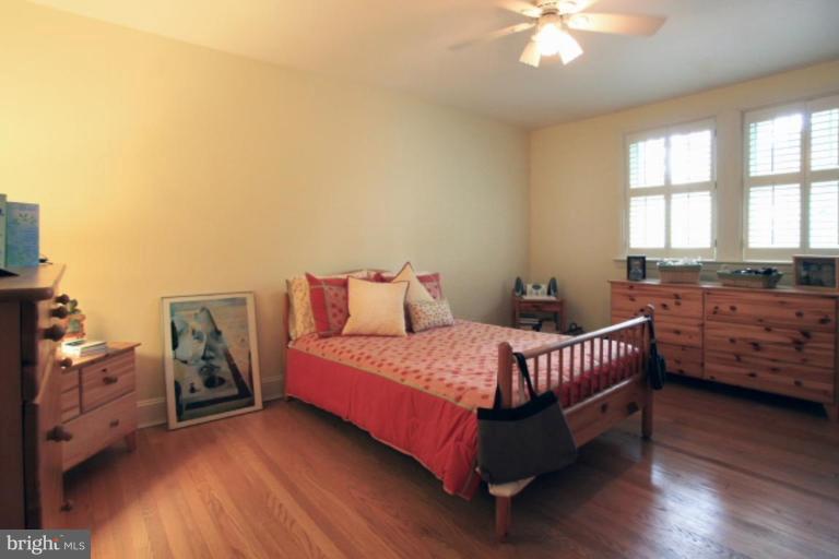 212 Dunkirk Road Baltimore, MD 21212 - Photo 14 of 30 a bedroom with a bed and a chandelier