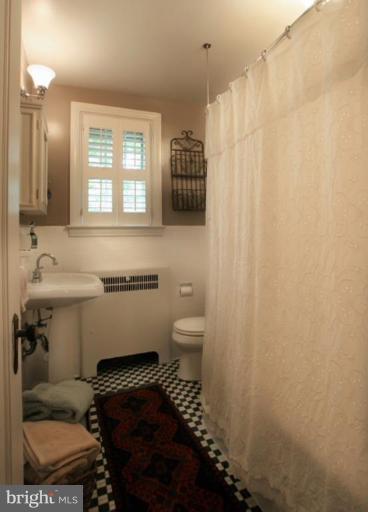 212 Dunkirk Road Baltimore, MD 21212 - Photo 15 of 30 a bathroom with a sink toilet and shower