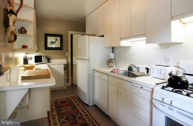 212 Dunkirk Road Baltimore, MD 21212 - Photo 20 of 30 a kitchen with a sink stove and refrigerator