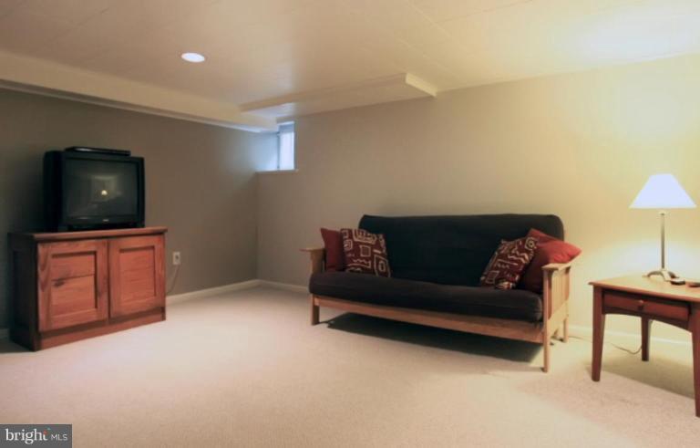 212 Dunkirk Road Baltimore, MD 21212 - Photo 23 of 30 a living room with furniture and a flat screen tv