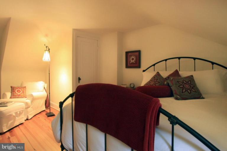 212 Dunkirk Road Baltimore, MD 21212 - Photo 27 of 30 a bedroom with a bed and wooden floor