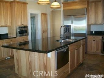 20552 Buchanan Hollow Road Le Grand, CA 95333 - Photo 17 of 26 a kitchen with stainless steel appliances granite countertop a sink and a refrigerator