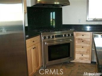 20552 Buchanan Hollow Road Le Grand, CA 95333 - Photo 18 of 26 a stove top oven sitting inside of a kitchen