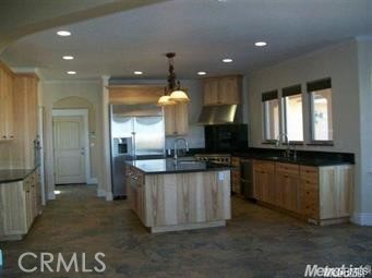 20552 Buchanan Hollow Road Le Grand, CA 95333 - Photo 19 of 26 a kitchen with stainless steel appliances granite countertop a stove a sink and a refrigerator