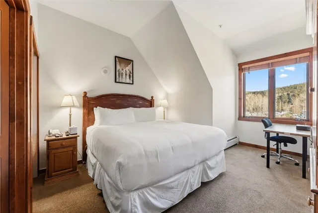 a bedroom with a bed and a table in it