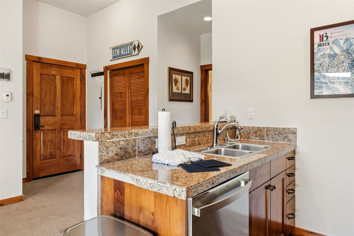 505 South Main Street, Unit 2403 Breckenridge, CO 80424 - Photo 10 of 29 a kitchen with a sink and a refrigerator