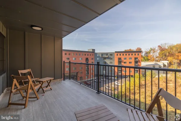 a balcony with chairs and wooden floor