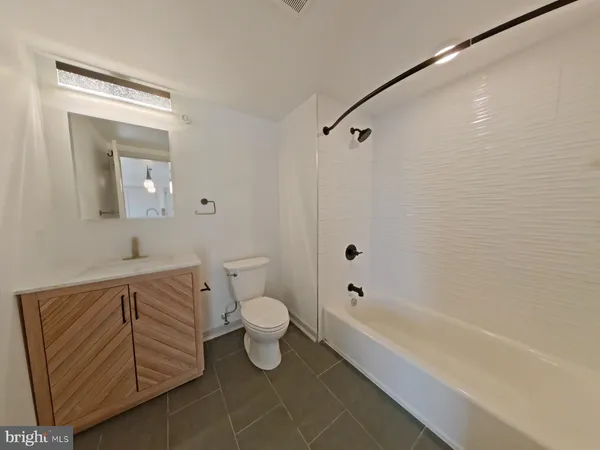 a bathroom with a toilet a sink and bathtub