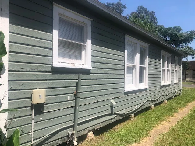 a view of a house with a small yard and a large window