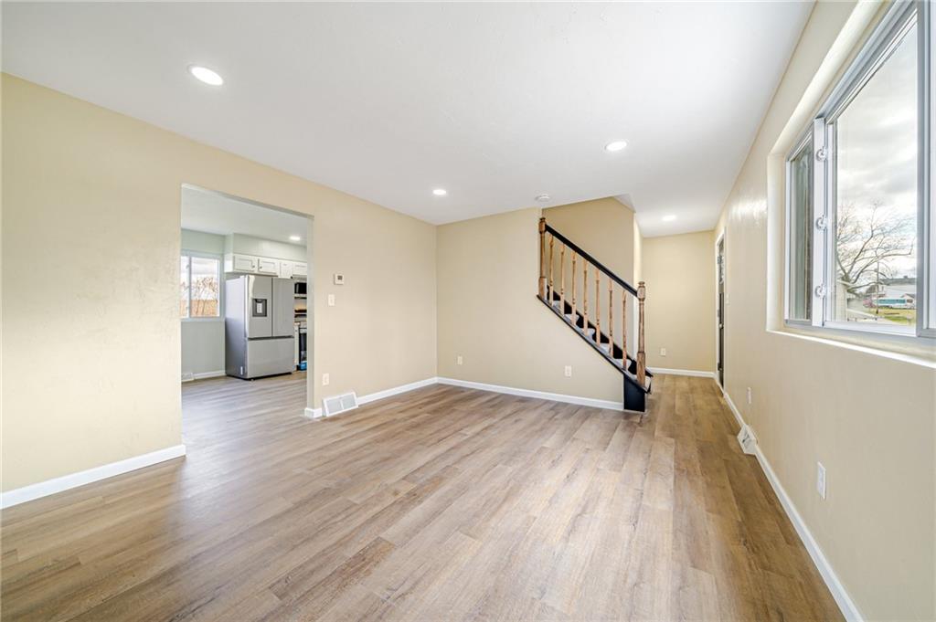 608 Fitz Henry Road Smithton, PA 15479 - Photo 12 of 40 a view of empty room with wooden floor and windows
