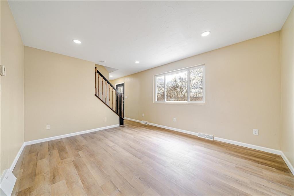 608 Fitz Henry Road Smithton, PA 15479 - Photo 13 of 40 a view of an empty room with wooden floor and a window