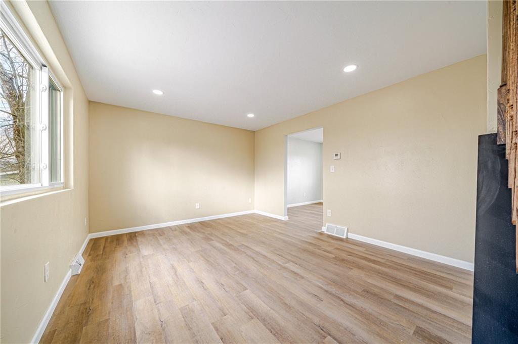 608 Fitz Henry Road Smithton, PA 15479 - Photo 14 of 40 a view of an empty room with wooden floor and a window