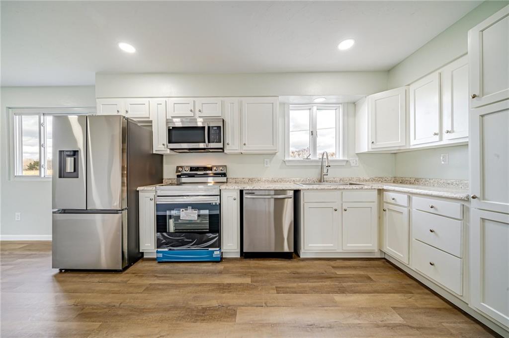 608 Fitz Henry Road Smithton, PA 15479 - Photo 2 of 40 a kitchen with granite countertop a refrigerator and a stove top oven