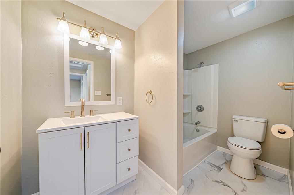 608 Fitz Henry Road Smithton, PA 15479 - Photo 23 of 40 a bathroom with a toilet sink and mirror with shower
