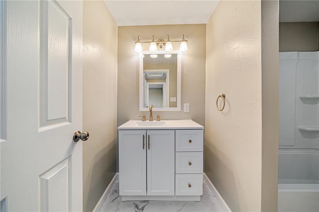 608 Fitz Henry Road Smithton, PA 15479 - Photo 24 of 40 a bathroom with a sink a mirror and shower