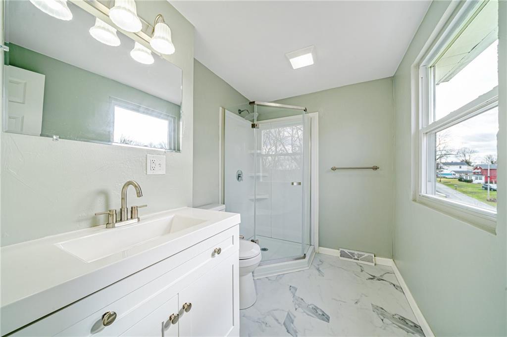 608 Fitz Henry Road Smithton, PA 15479 - Photo 28 of 40 a bathroom with a sink mirror vanity and toilet