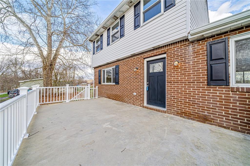 608 Fitz Henry Road Smithton, PA 15479 - Photo 33 of 40 a view of a house with a wooden fence