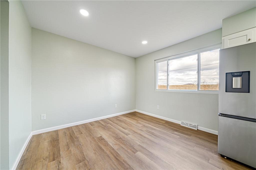 608 Fitz Henry Road Smithton, PA 15479 - Photo 8 of 40 an empty room with wooden floor and windows