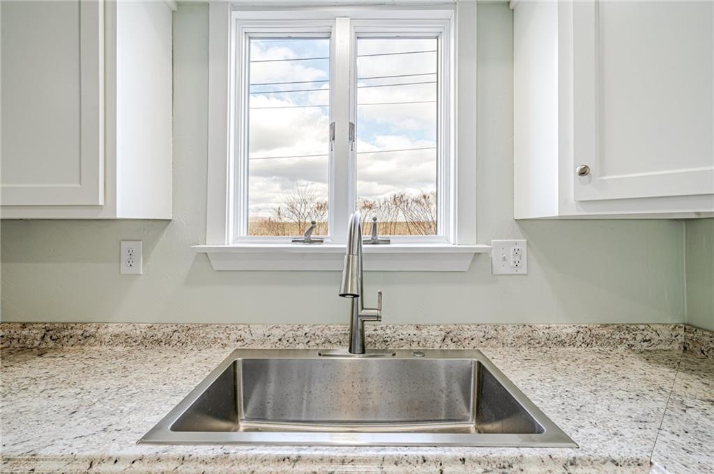 608 Fitz Henry Road Smithton, PA 15479 - Photo 9 of 40 a kitchen with a sink granite counter tops and a window